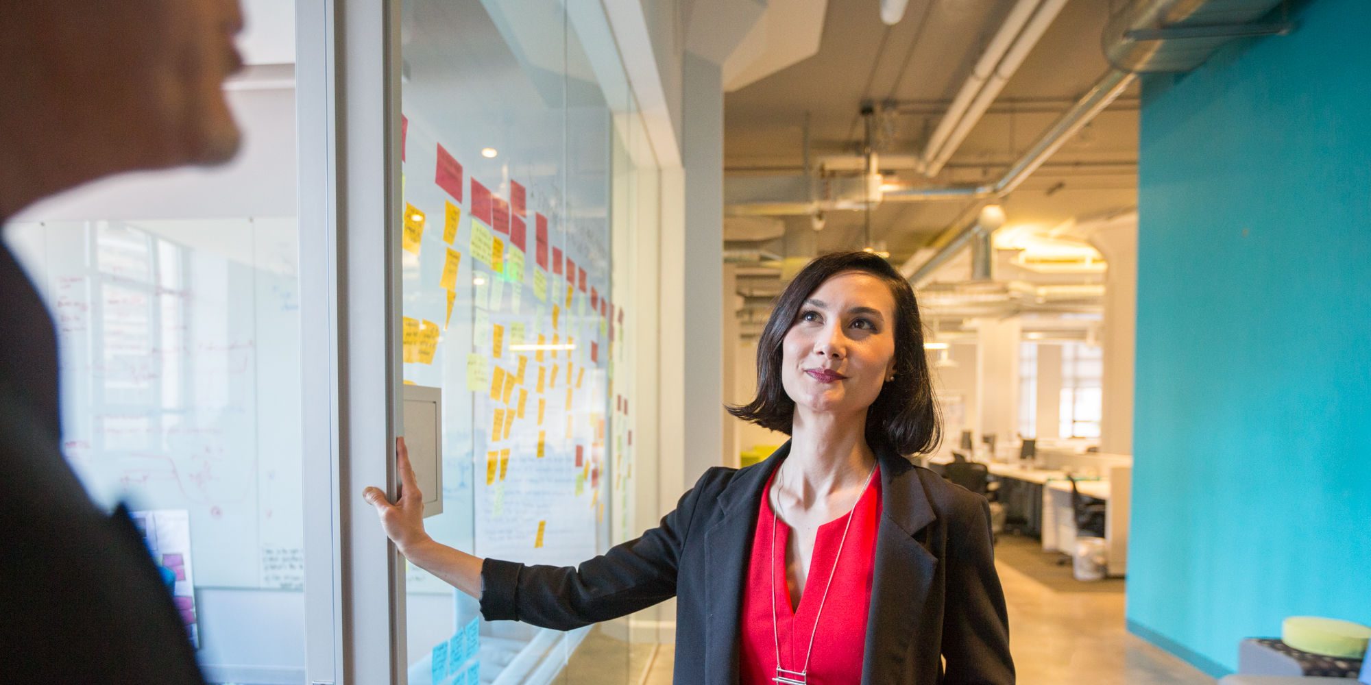 Business woman at window with post-its