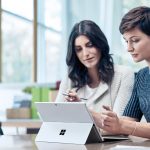2 women working on a Microsoft Surface