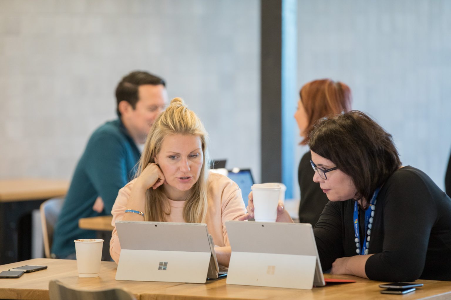 2 people meeting with two surfaces on the table