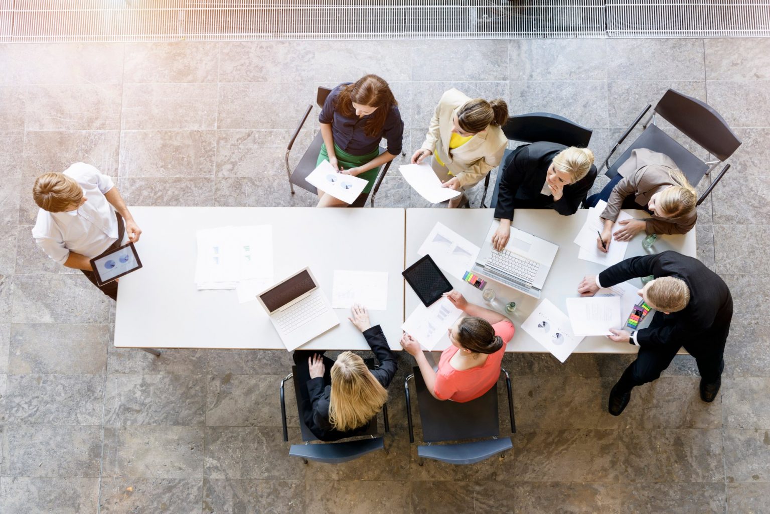 the image looks down on 7 people having a meeting