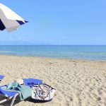 A sunbed and an umbrella overlooking the ocean