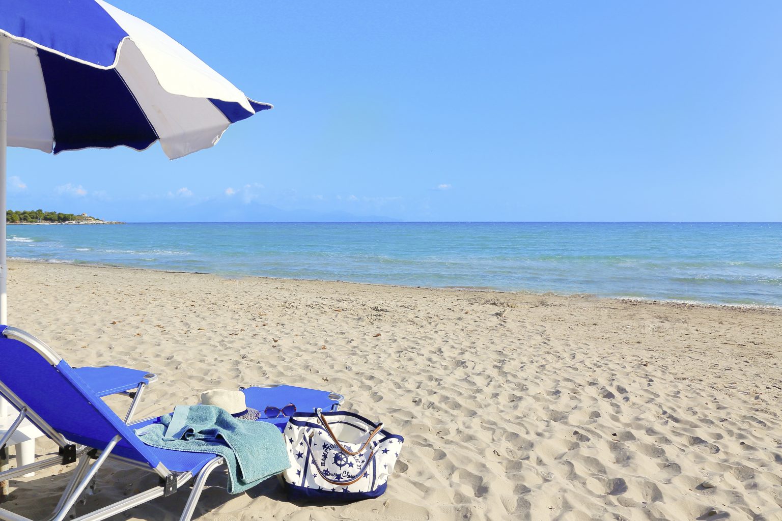 A sunbed and an umbrella overlooking the ocean