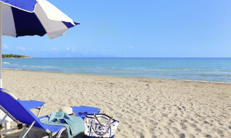 A sunbed and an umbrella overlooking the ocean