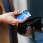 Woman taking a credit card out of a wallet