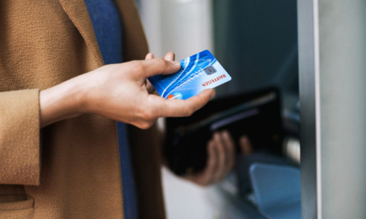 Woman taking a credit card out of a wallet