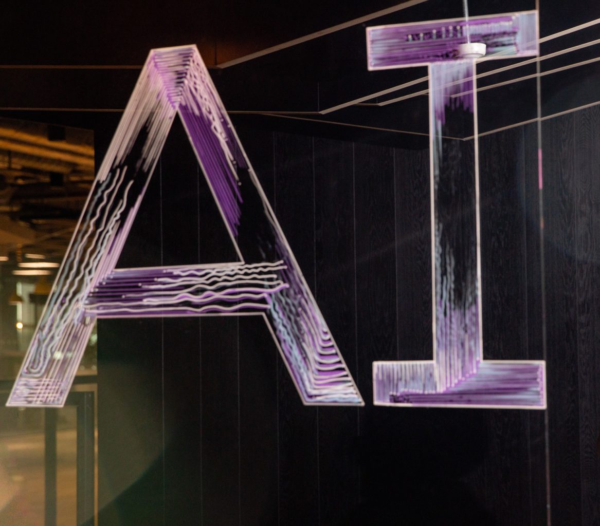 AI spelled in neon letters