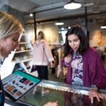 Retail worker helping a customer using a Surface Laptop