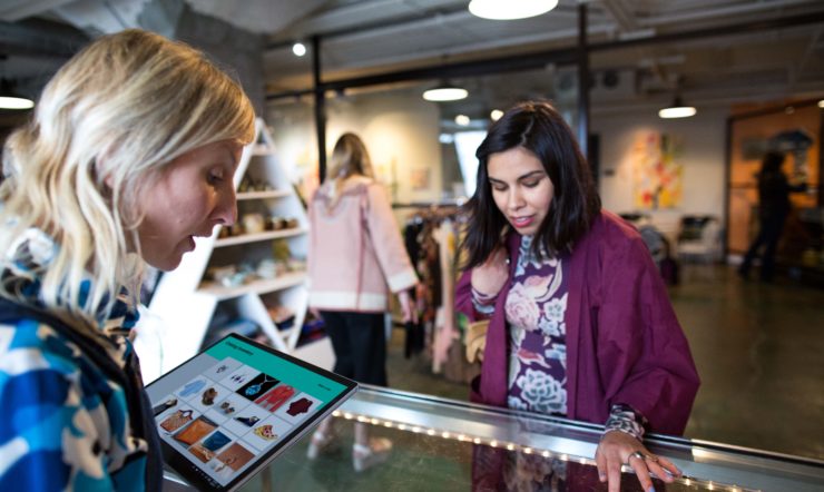 Retail worker helping a customer using a Surface Laptop