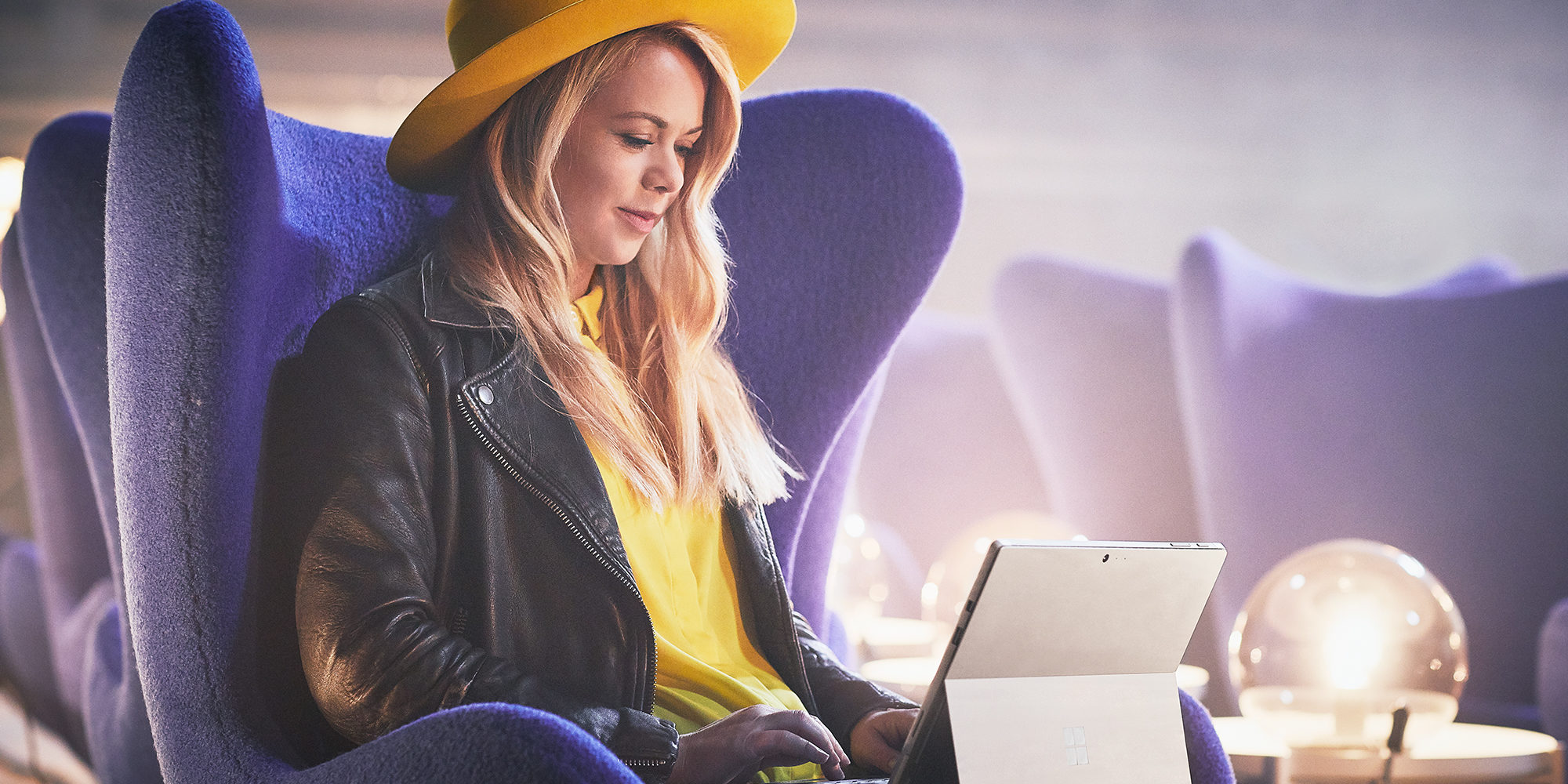 Sofie using Surface in airport lounge