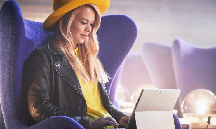 Sofie using Surface in airport lounge