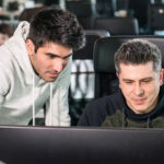 a man sitting in front of a laptop computer