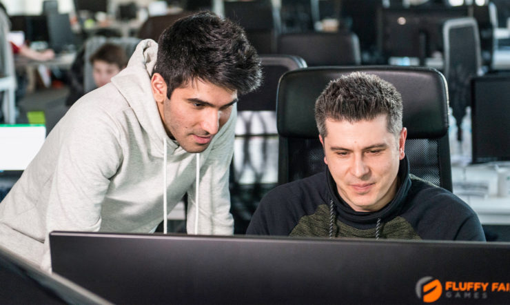 a man sitting in front of a laptop computer