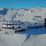 a group of people standing on top of a snow covered mountain