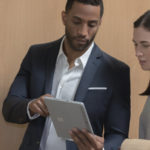 Two people inside using Surface Go in office