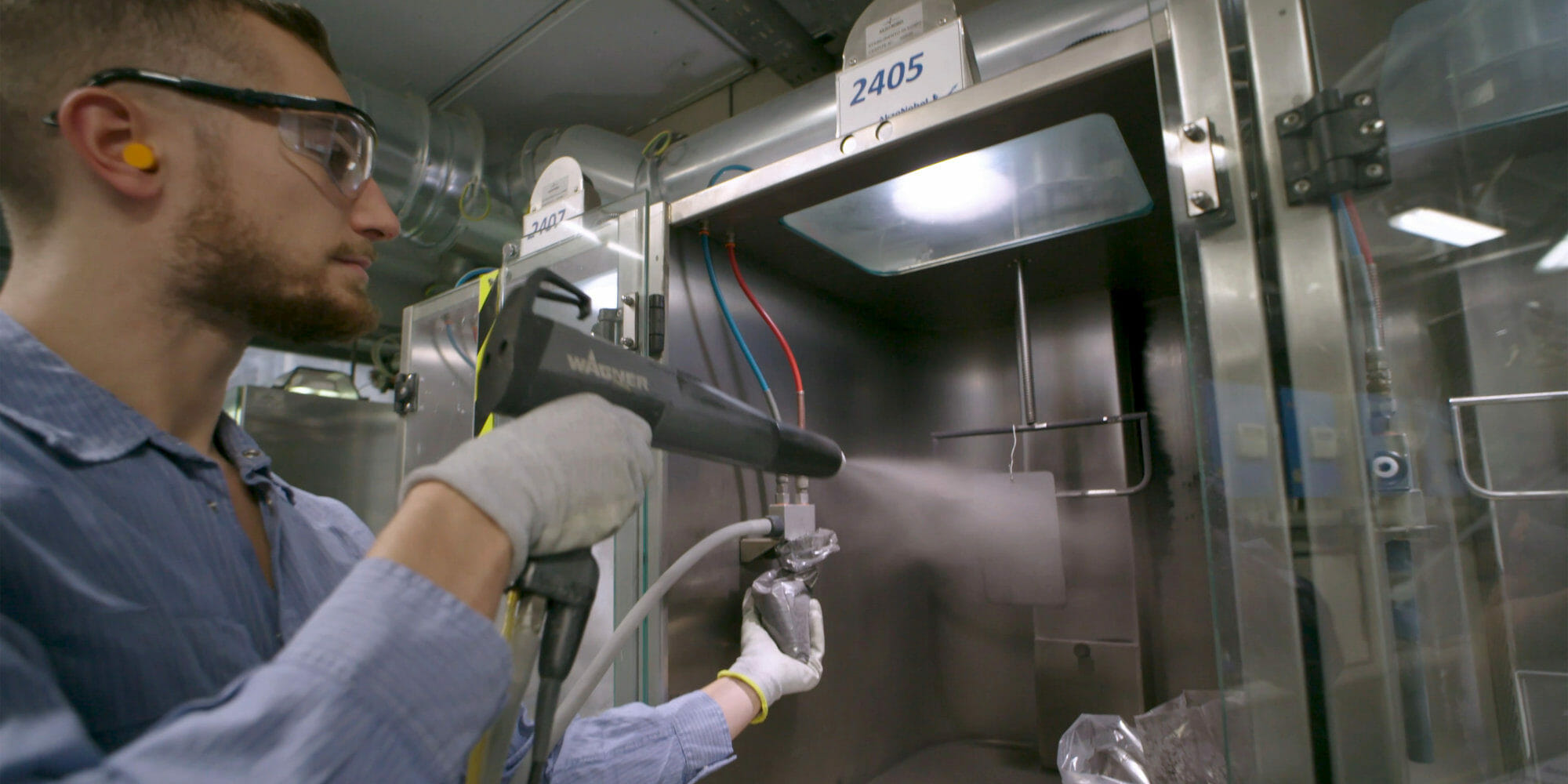 a man holding a paint spray