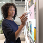 Woman executive working on Surface Hub 2S in Whiteboard with Surface Hub 2 Pen