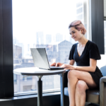 Female worker using laptop in financial office