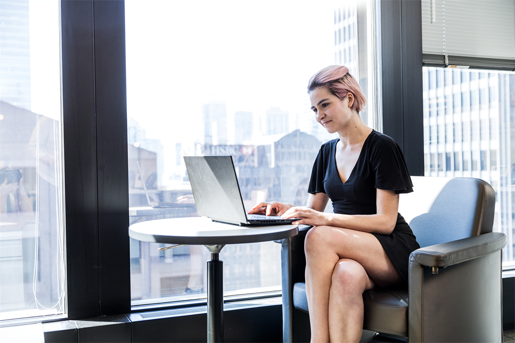 Female worker using laptop in financial office