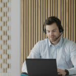 a person sitting in front of a laptop computer