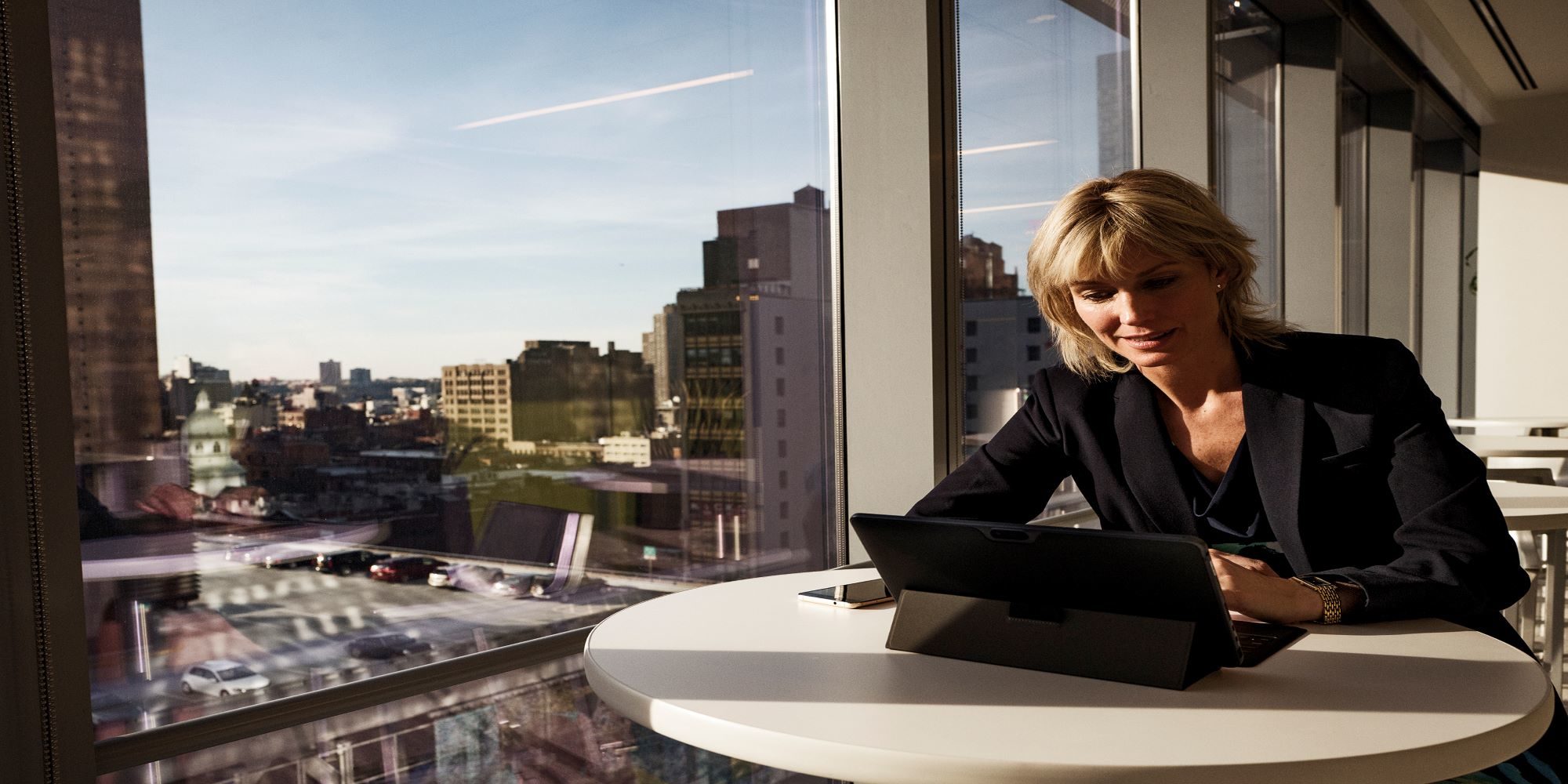 a woman sitting at a table in front of a building