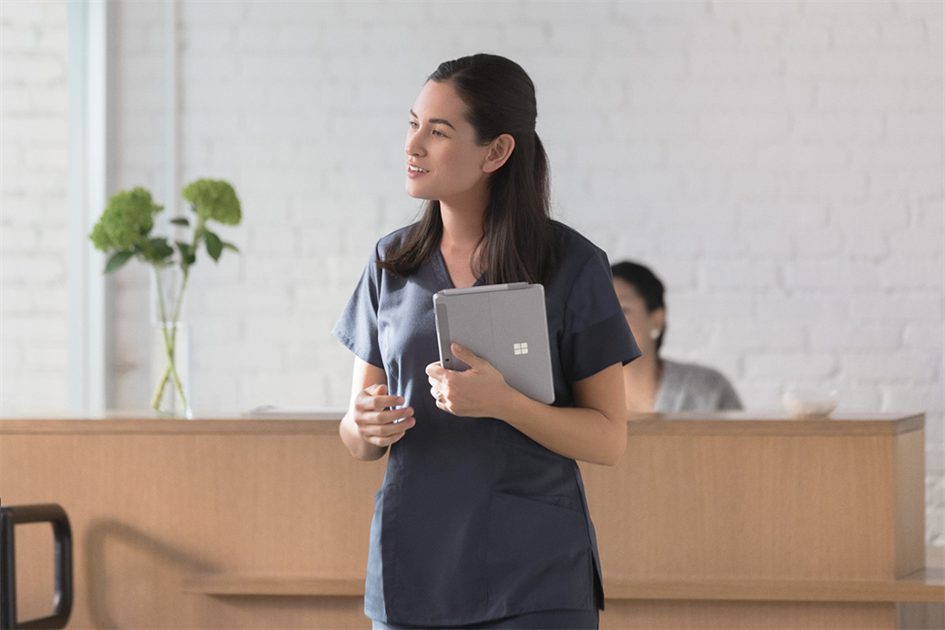 First line worker using Surface Go in medical office. Contextual first line worker.