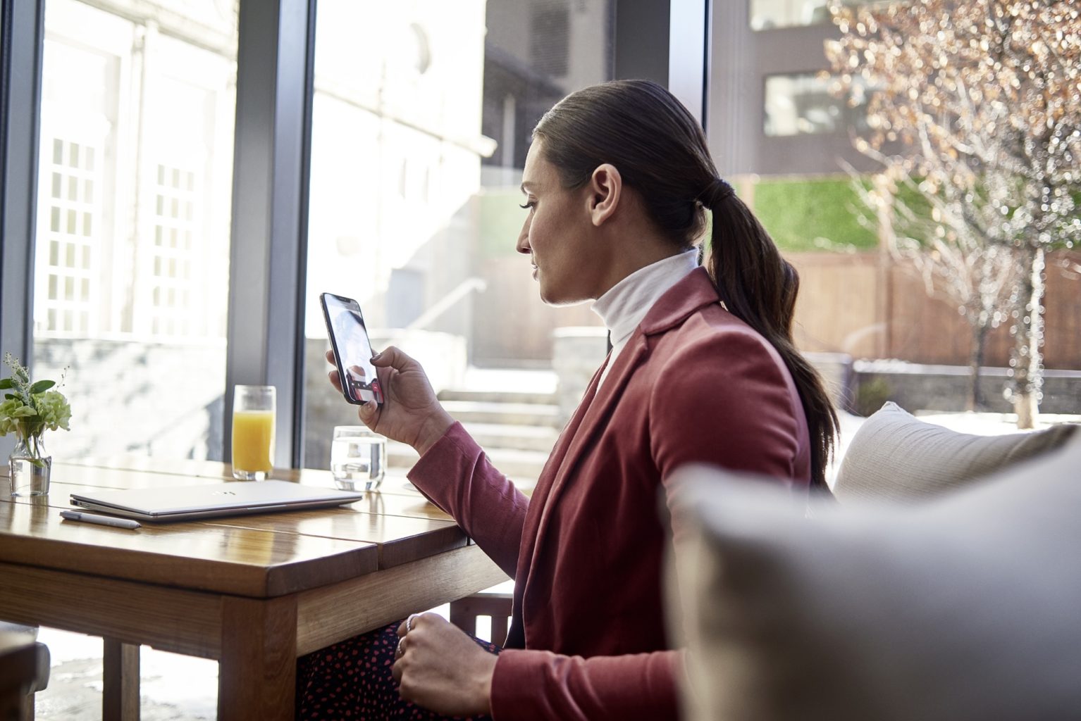 a person sitting at a table in front of a window