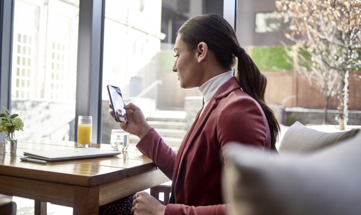 a person sitting at a table in front of a window