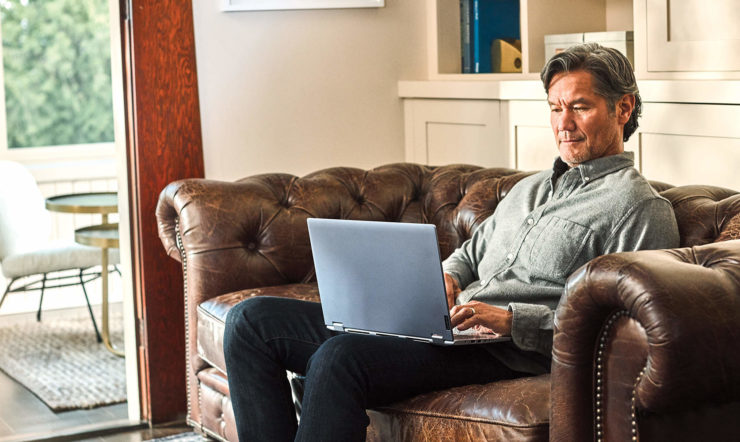 a man sitting in a living room with a leather chair