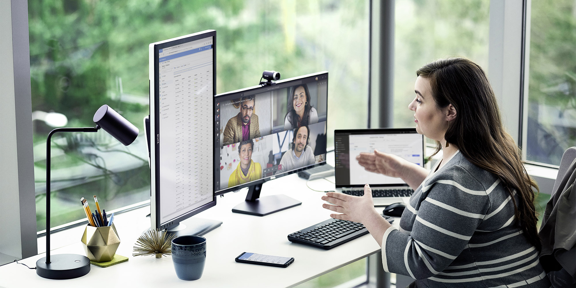 a person sitting at a desk in front of a laptop computer