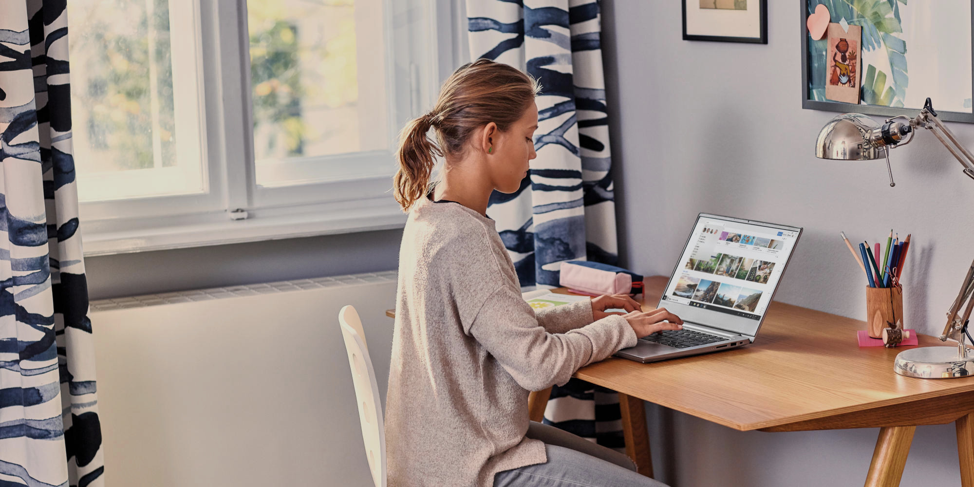 a person sitting at a table using a laptop