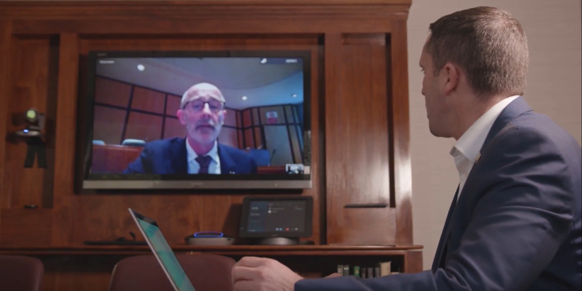 a man standing in front of a television