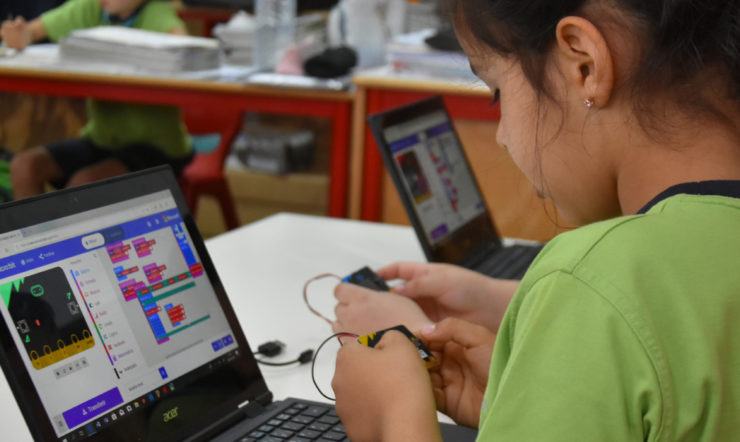 a young boy using a laptop computer