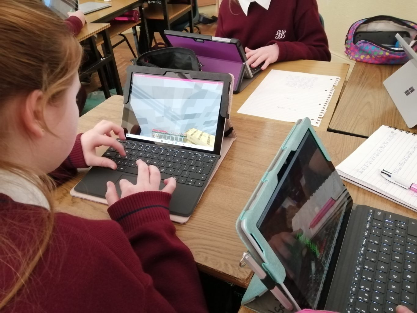 a woman sitting at a table using a laptop