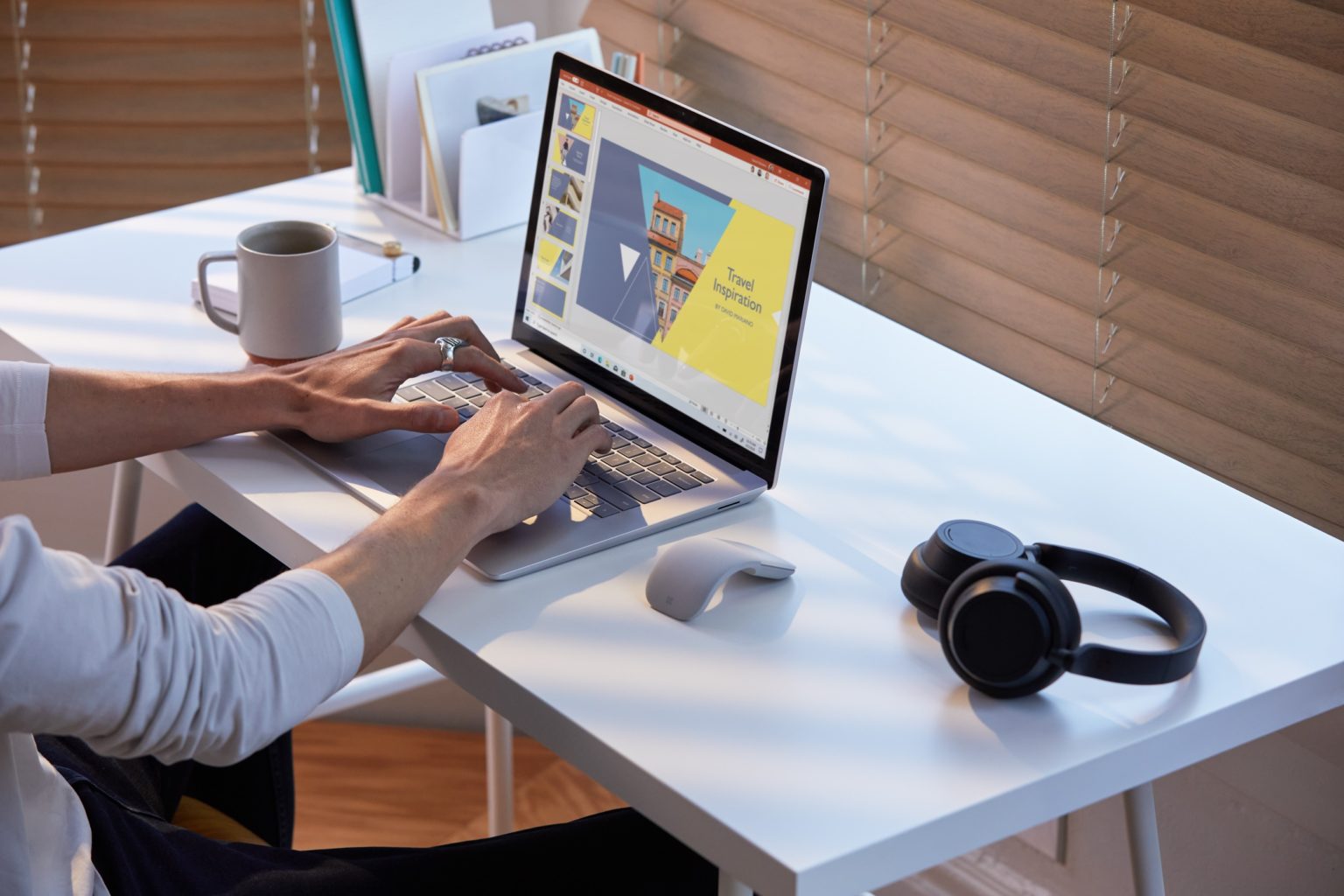 a person sitting at a desk in front of a computer