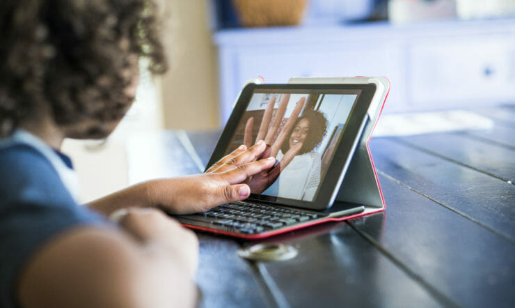 a person using a laptop computer sitting on top of a table