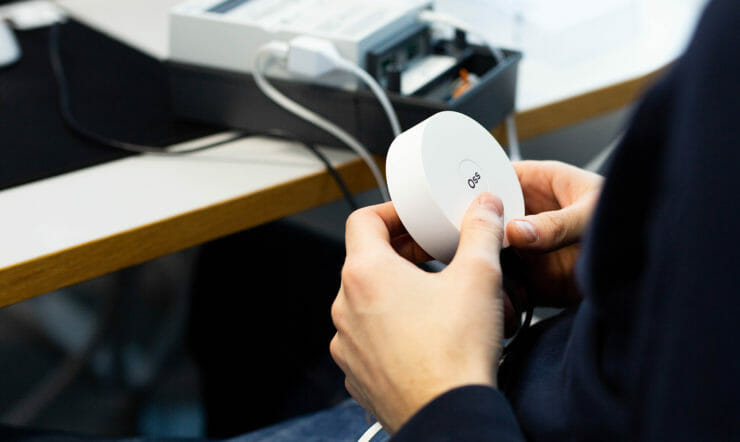 a hand holding a video game remote control