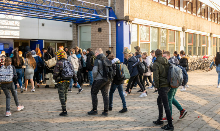 A group of students in front of a school