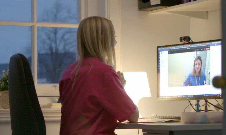 Two female nurses having a virtual conversation through Microsoft Teams