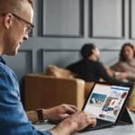 a man sitting in front of a laptop