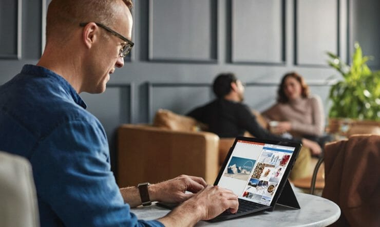 a man sitting in front of a laptop