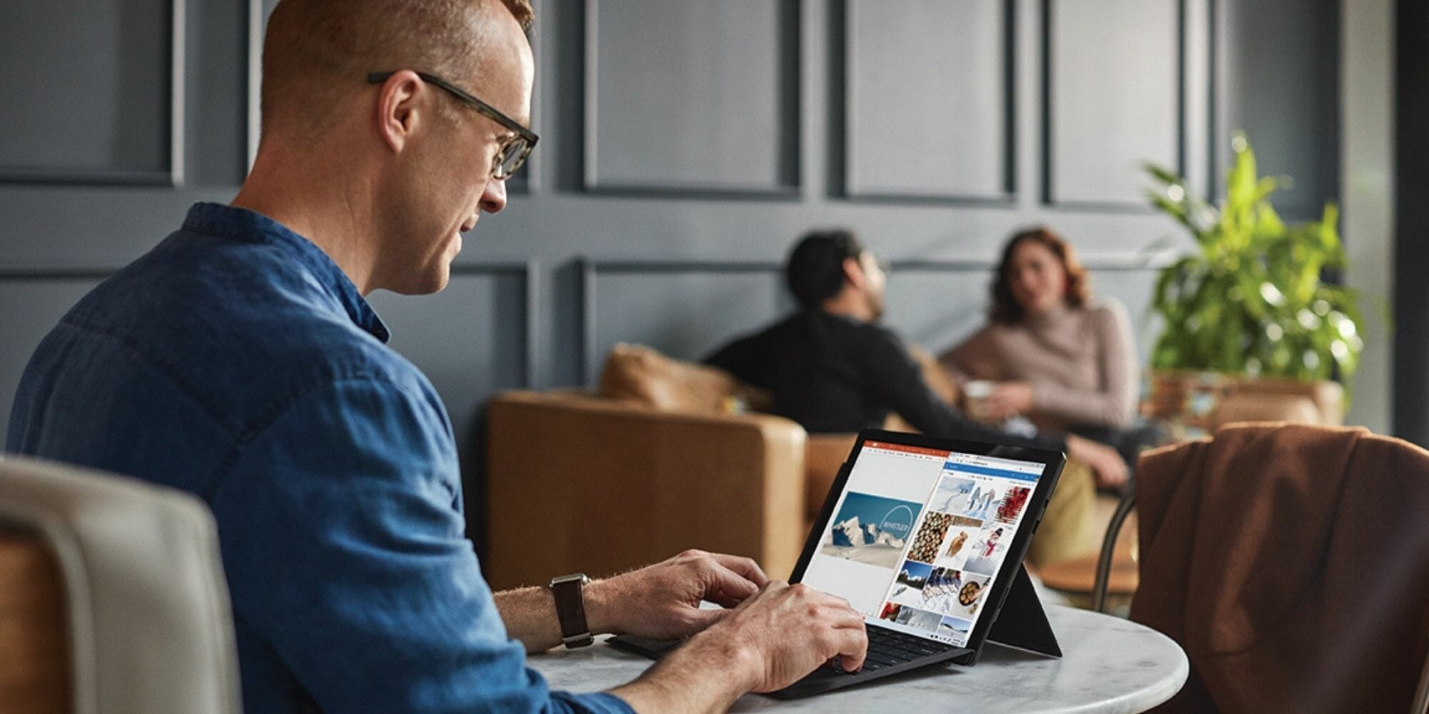 a man sitting in front of a laptop