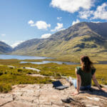 a person standing in front of a mountain