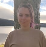 en person som står foran en kropp av vann