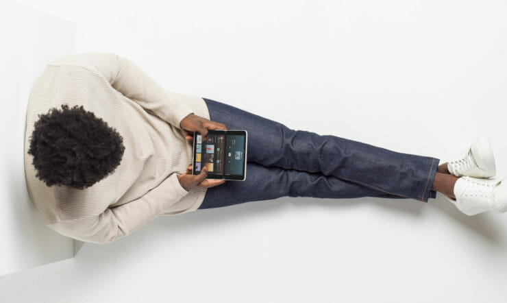 Adult male using Surface Duo in compose mode while listening to Spotify