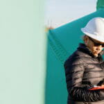 Adult woman in an industry holding a tablet