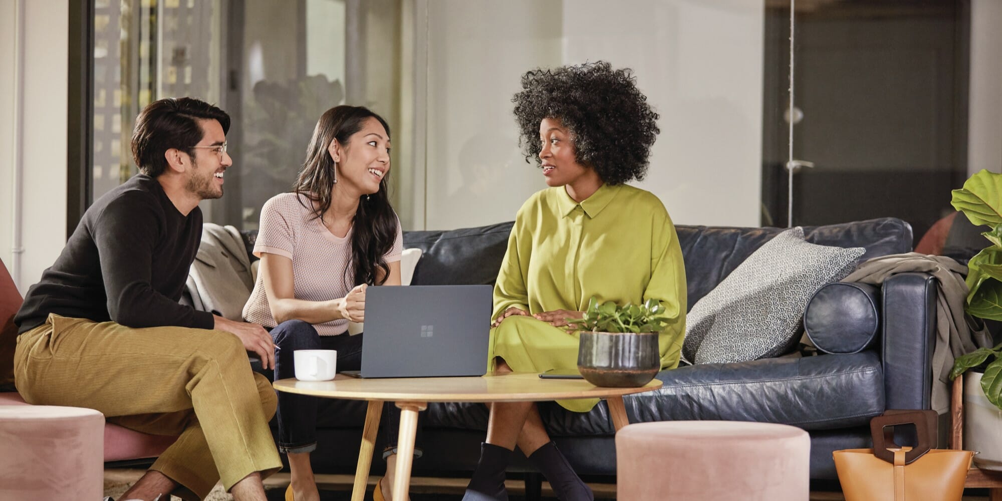 Employees collaborate in front of Surface devices