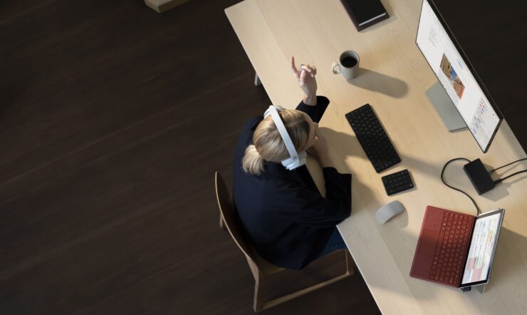 Woman on desk, Surface Devices infront of her