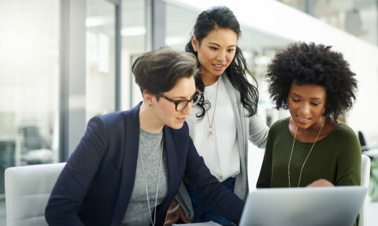 three women watching a computer