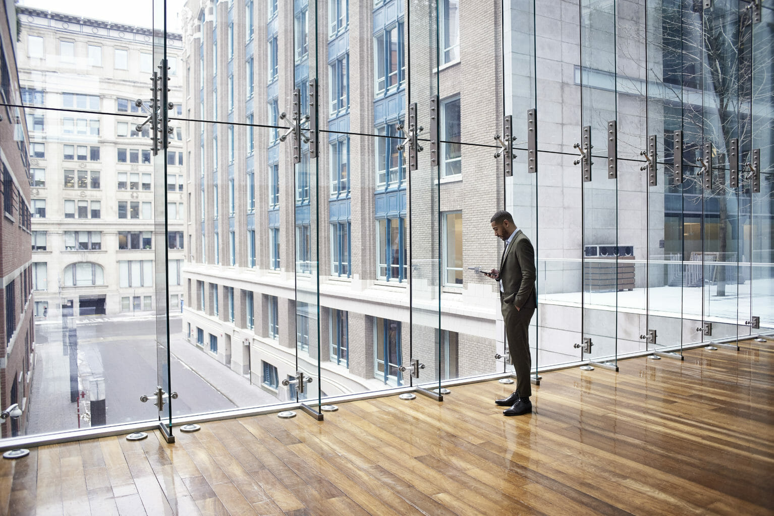 man in front of glass building
