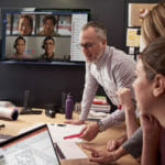 Female & Male employees collaborating using PowerPoint and Microsoft Teams.